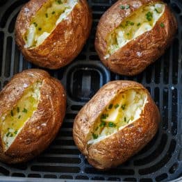 Air Fryer Baked Potatoes in the air fryer basket