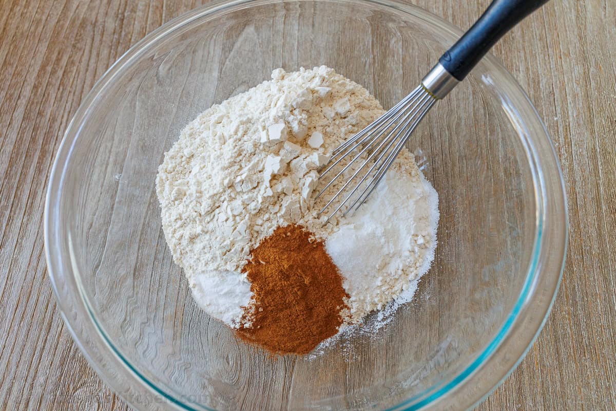 Whisk mixing dry ingredients in a clear bowl