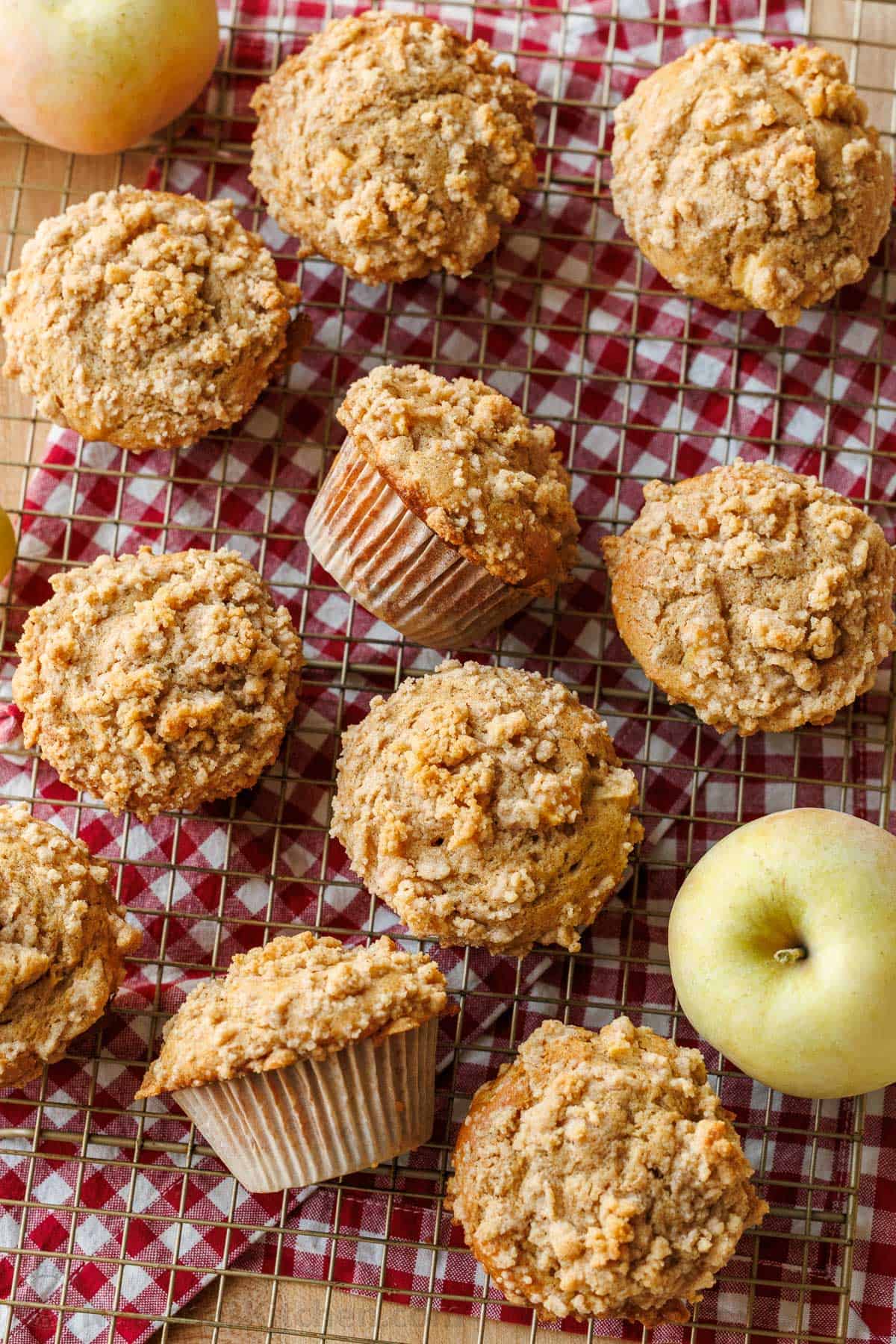 Apple muffins on a baking rack on a red checkered cloth