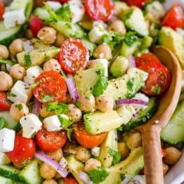 Chickpea Salad loaded with crisp cucumbers, juicy tomatoes, creamy avocado, feta cheese and chickpeas or garbanzo beans. Fresh, healthy and protein packed! #chickpeasalad #garbanzobeansalad #chickpeas #chickpeasaladrecipe #salad #saladrecipe #fetacheese #tomatosalad #avocadosalad #greeksalad #mediterraneansalad #natashaskitchen