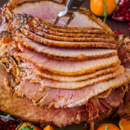 Baked Ham with apricot brown sugar honey glaze on platter