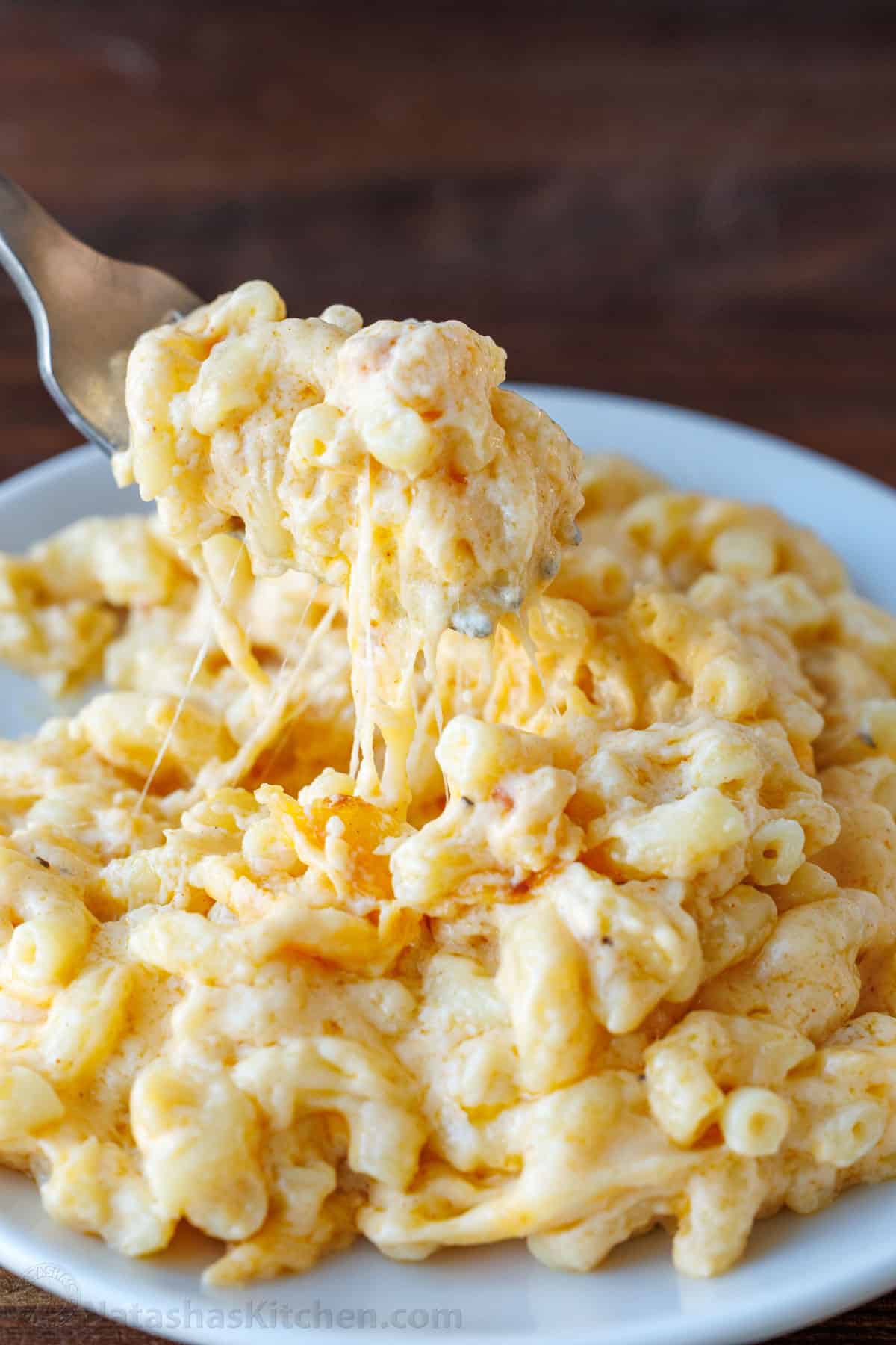 Baked Mac and Cheese on a white plate with a fork
