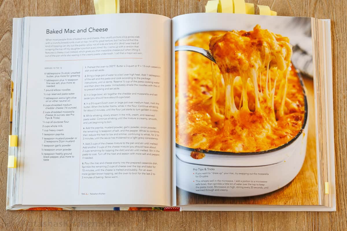 Natasha's Kitchen Cookbook open on the counter showing the easy Baked Mac and Cheese Recipe