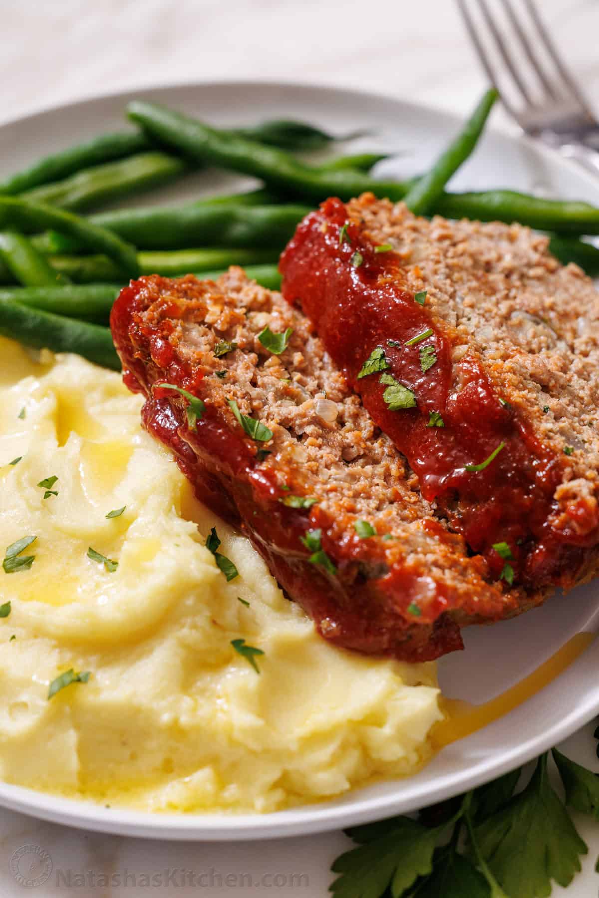Meatloaf Served with mashed potatoes and green beans on a plate
