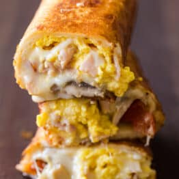 Stack of cheesy breakfast burritos