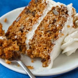 Carrot cake slice served on a plate with fork