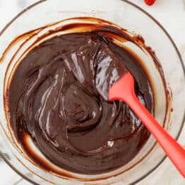 Chocolate ganache mixed in a glass bowl