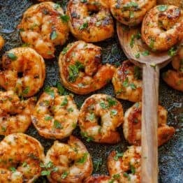 Grilled Cilantro Lime shrimp on a skillet with a wooden spoon