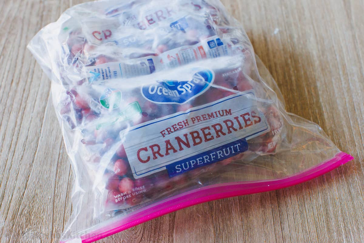 Bags of frozen cranberries sealed inside a large zip-top bag.