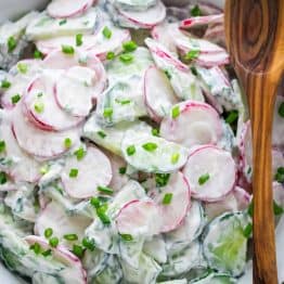 Creamy cucumber radish salad in a white bowl