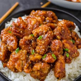 General tsos chicken served over a bowl of white rice