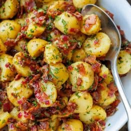 German Potato Salad with bacon bits and parsley tossed in a dijon mustard and vinegar dressing