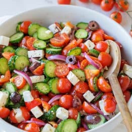 Greek Salad recipe with the best Greek Salad dressing in a a white bowl