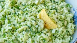 Green Goddess Salad in a bowl with corn chips around