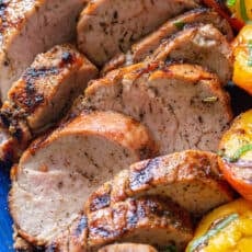 Grilled pork tenderloin medallions sliced on a plate
