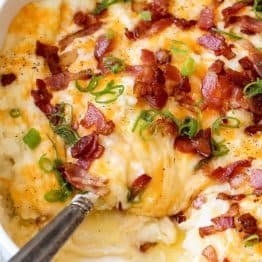 Loaded Mashed Potato Casserole is the perfect side dish. These irresistibly creamy baked mashed potatoes are loaded with cheese and topped with crispy bacon.