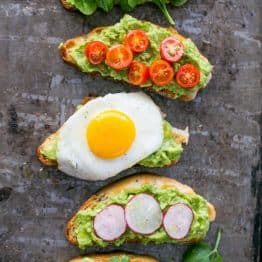 Five varieties of open-faced avocado spread sandwiches
