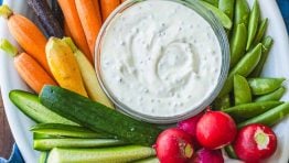 Vegetable platter with Ranch dip on a blue towel