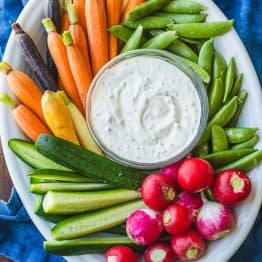 Vegetable platter with Ranch dip on a blue towel
