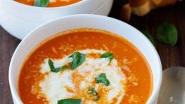 Two bowls of Roasted Tomato soup recipe with Grilled Cheese and a spoon