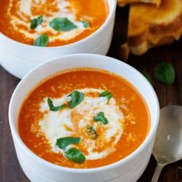 Two bowls of Roasted Tomato soup recipe with Grilled Cheese and a spoon