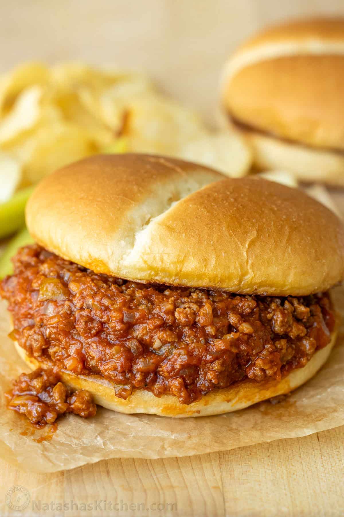 Sloppy Joes with some meat sauce spilling out of the bun