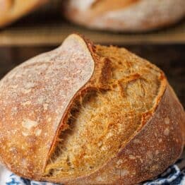 Sourdough bread boule with blue and white tea towel