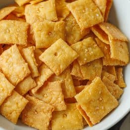 Sourdough cheese crackers, discard recipe, baked and lightly salted, served in a white bowl