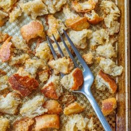 Sourdough Croutons on a baking sheet with a fork.