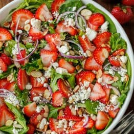 strawberry salad with honey vinaigrette in a white bowl