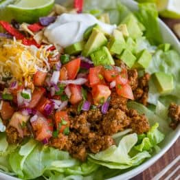 Taco Salad served with toppings in a white bowl