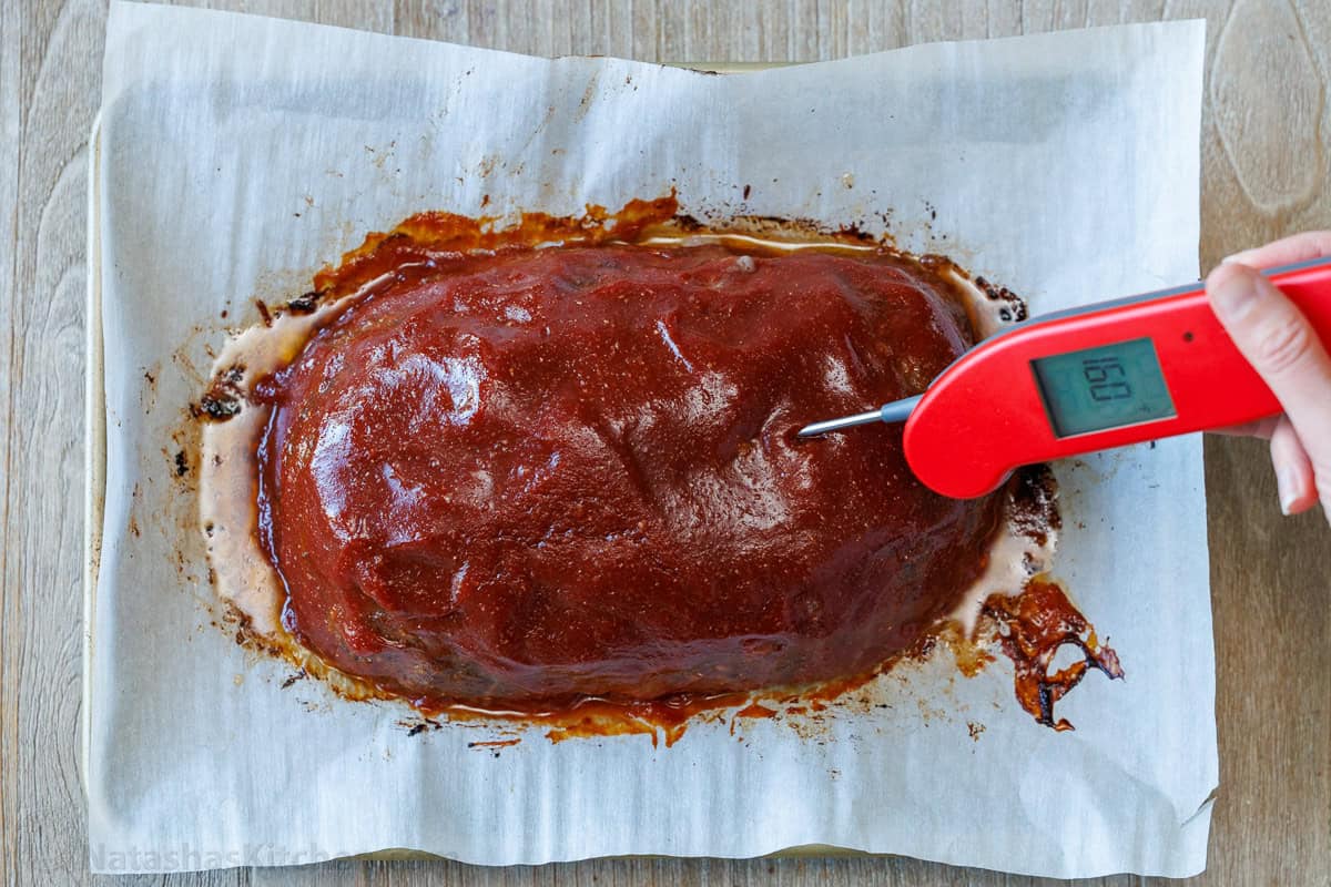 Testing meatloaf doneness with instant-read thermometer