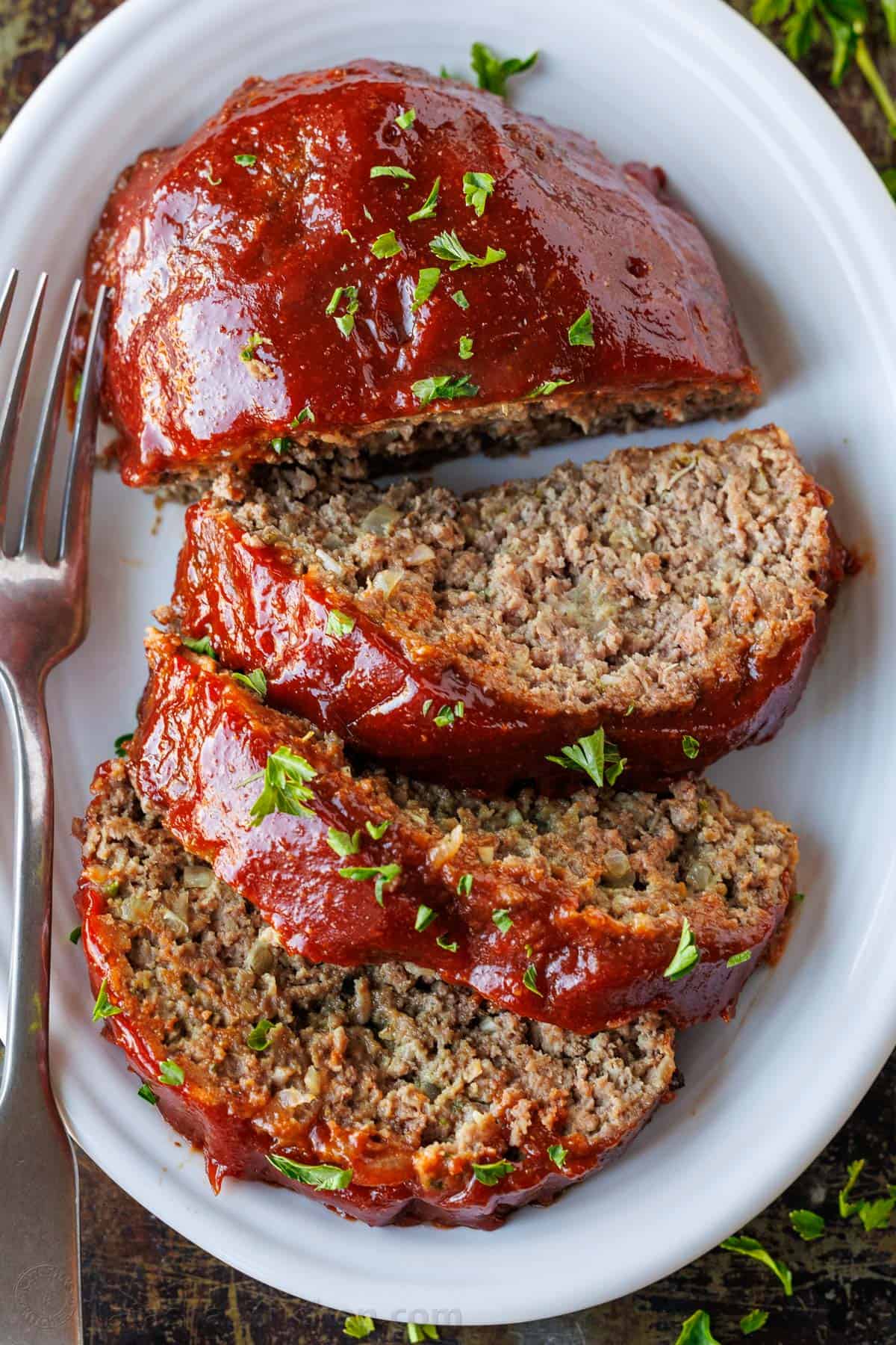 The Best Meatloaf sliced and served on a white platter