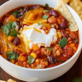 Bowl of the best turkey chili recipe with tortilla chips on the side